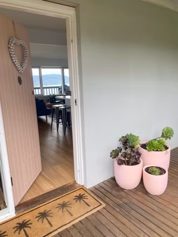 Front door of Mar Vista open to the living room and bay beyond